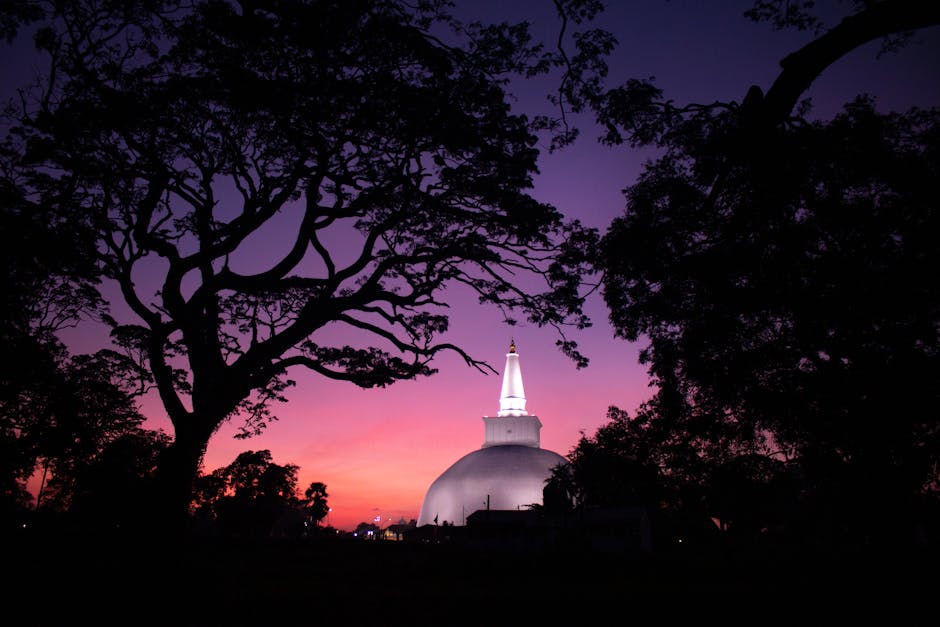 Illuminated White Dome of Ruwanweli Maha Seya Stupa Surrounded by Trees in the Evening